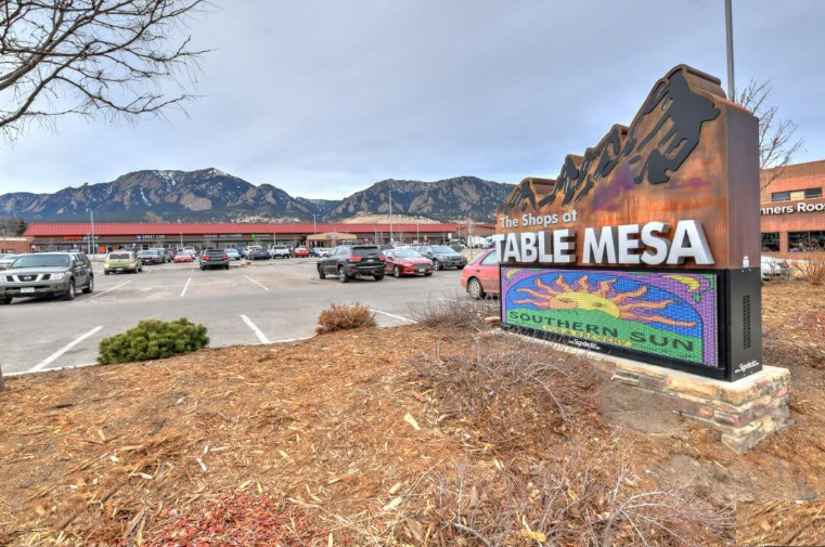 The Shops at Table Mesa in South Boulder, Colorado — the early-1960s shopping center monument sign with Southern Sun Pub marquee and the Flatirons rising behind